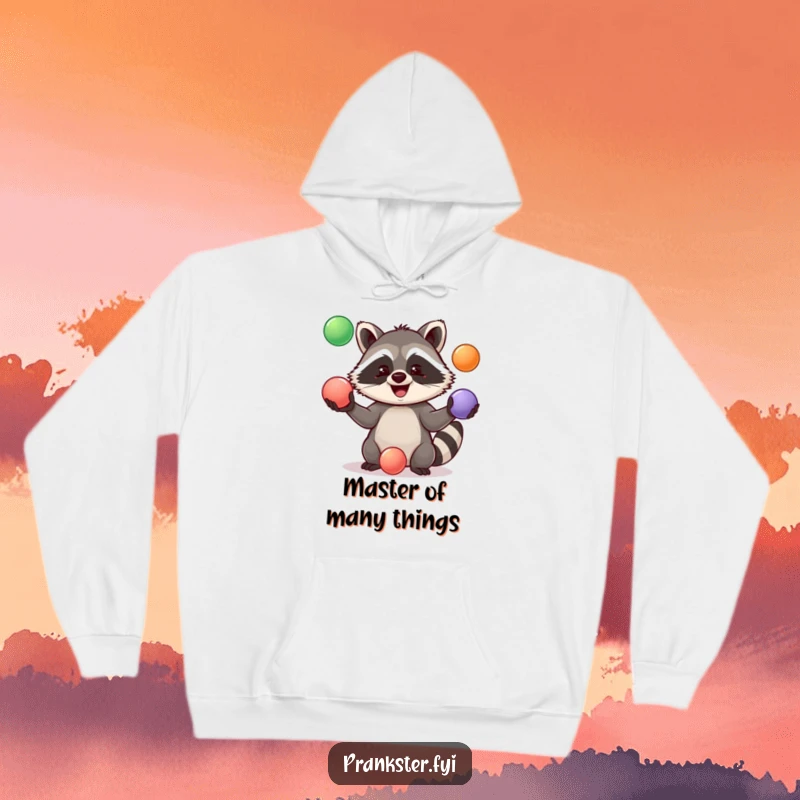 Funny Hoodie with a happy raccoon caught in the act of juggling three vibrant balls, radiating fun and warmth.