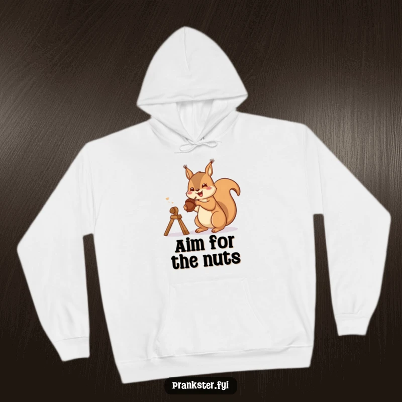 Funny hoodie depicting a gleeful squirrel preparing to launch an acorn from a slingshot, symbolizing playful ambushes.