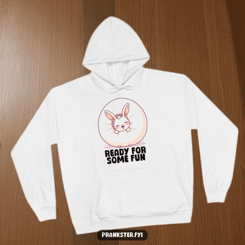Funny hoodie featuring a giggling rabbit peeking from behind a whoopee cushion, perfect for staying warm with humor.