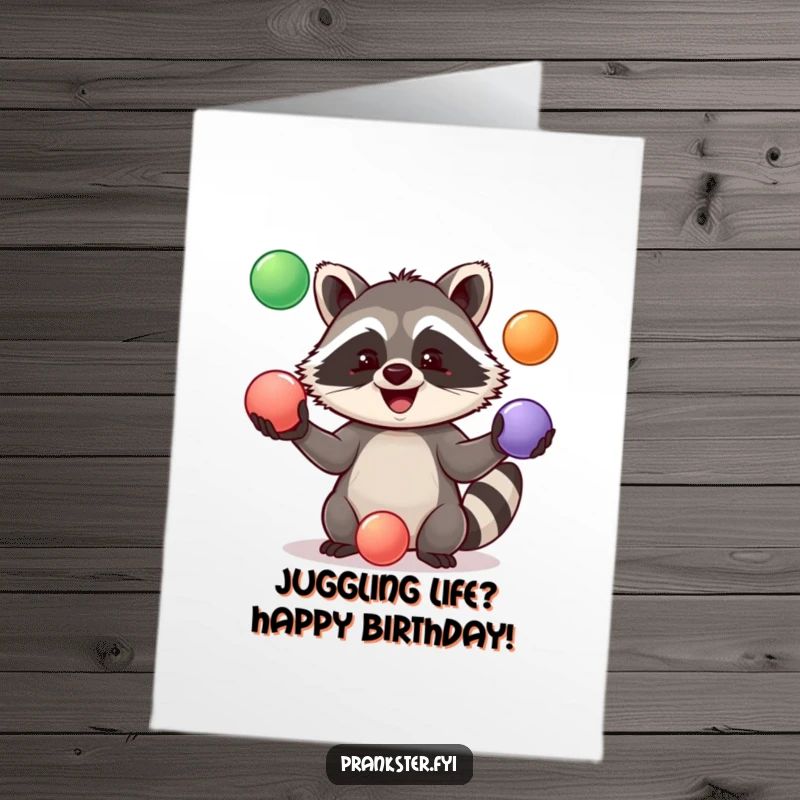 Funny Free Printable birthday card of a jolly raccoon expertly juggling three bright rubber balls, full of playful energy.